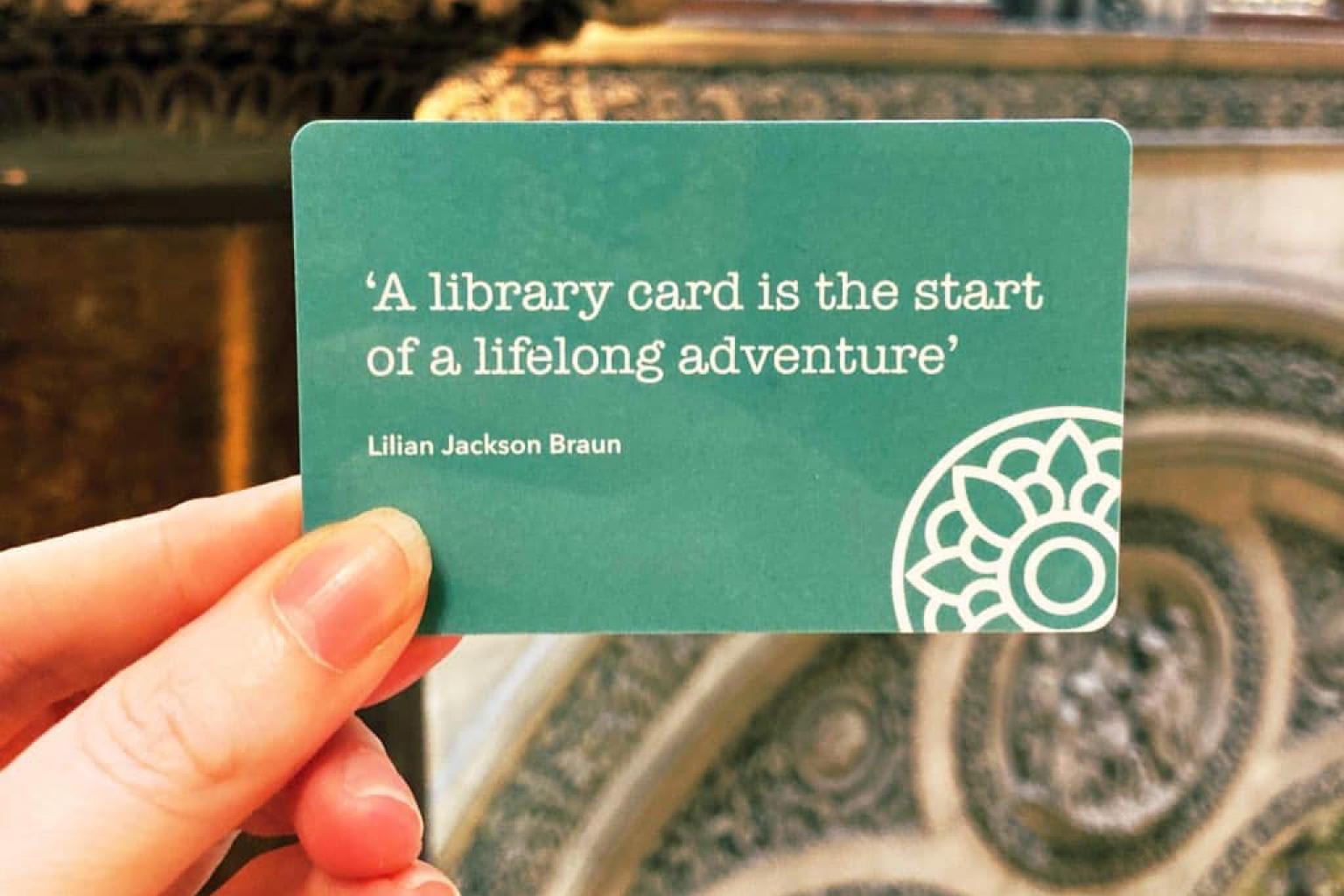 Picture of a library card with the quote 'A library card is the start of a lifelong adventure' - Lilian Jackson Braun