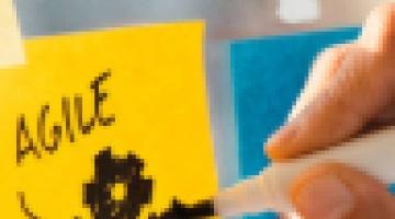 Writing agile on a yellow notepad